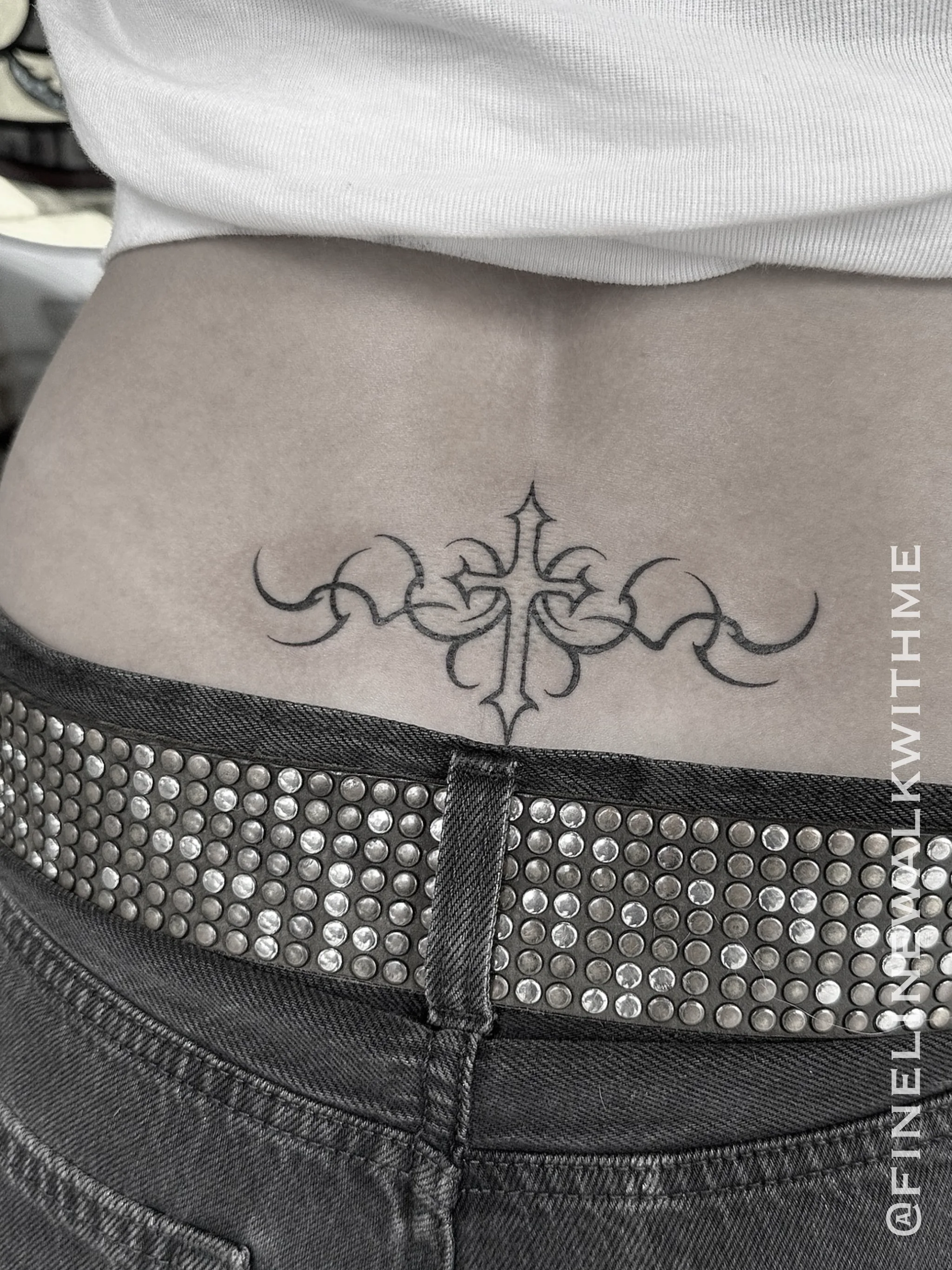 Fine line lower back ornamental tattoo by FineLineWalkWithMe